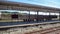 Empty platform with station sign and wooden seats in train station for background