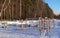 Empty playground for children on a frosty snowy winter day covered with snow without people. Russian playground. Maritime military