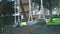 Empty playground with swinging lone swing with chain and black seat.