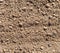 Empty plowed dry soil under sunlight