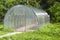 An empty polycarbonate greenhouse on a forest background