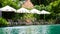 Empty poolside loungers with umbrellas