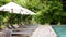 Empty poolside loungers with umbrellas