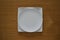Empty porcelain plate on a wooden table top