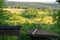 Empty portable BBQ grill in front of a fresh green summer landscape, close-up