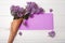 Empty postal envelope and bouquet of lilac flowers