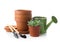 Empty pots with gardening tools on white background