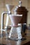 Empty pour over with paper filter on a wooden table in cofffee shop