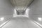 Empty public underground parking lot or garage interior with concrete stripe painted columns and signs.