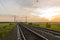 Empty railroad with pillars at sunset