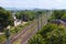 Empty railroads through lush green trees on a sunny day