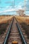 Empty railway in country side against a blue sky with clouds. Concept of transport. No trail vehicle. Vertical composition. Travel