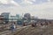 Empty railway tracks on the background of modern trains with cars and city buildings, aerial view