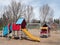 Empty Red, Blue, and Gold Playground Equipment in City Park