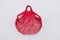 Empty red cotton eco mesh bag on grey. Eco friendly
