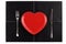 Empty red heart plate knife fork on black leather