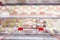 Empty red shopping cart with Abstract fresh meat shelves in supermarket grocery store blurred defocused background