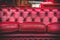 Empty red sofa in cosy lounge room old-fashioned vintage closeup