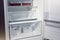 Empty refrigerator shelves, view of the lower part of the compartment for storing vegetables