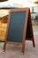Empty restaurant menu blackboard on the street, menu chalkboard mockup, menu board template