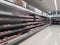 Empty retail shop shelves in chiller meat section in supermarket.  Low supplies due to stockpiling by customers consumers