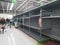 Empty retail shop shelves in supermarket.  Low supplies