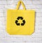 Empty reusable yellow viscose bag on a white background