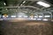 Empty riding hall with sandy covering