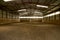 Empty riding hall with sandy covering without riders as an equestrian background