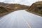 An empty road across barren hills of upper Tibet region
