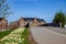 empty road and bridge, beautiful blooming daffodils and historical architecture