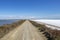 Empty road in Camargue through salt lagoons in Camarque regional nature reserve, Provence Alpes Cote Azur, France