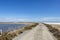 Empty road in Camargue through salt lagoons in Camarque regional nature reserve, Provence Alpes Cote Azur, France