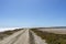 Empty road in Camargue through salt lagoons in Camarque regional nature reserve, Provence Alpes Cote Azur, France