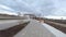 Empty road and channel in young city park under heavy clouds