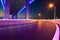 Empty road floor with city viaduct bridge of neon lights night