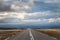 Empty road in Iceland driving in sunshine towards bad weather in the Highlands