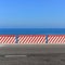 Empty road - ocean and blue sky background