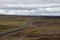 Empty road in rural Icelandic landscape.