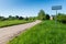 Empty road with sign for village name