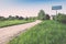 empty road with sign for village name - retro vintage look