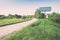 empty road with sign for village name - retro vintage look