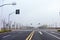 Empty road with traffic lights and crosswalks against the background of the sky.