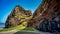 an empty roadway that has some rocks on it, in the foreground