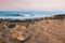 Empty rocky beach of Cyprus island at sunrise