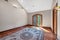 Empty room with a beautiful carpet, laminate flooring and white walls in a mansion