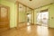 empty room with built in wardrobe with mirrored sliding doors and oak trim and pistachio green painted walls