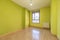 Empty room with a built-in wardrobe with white sliding doors and a dark wooden access door and plain white painted walls