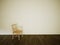 Empty room chair on white wall