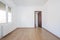 Empty room with chestnut parquet floors